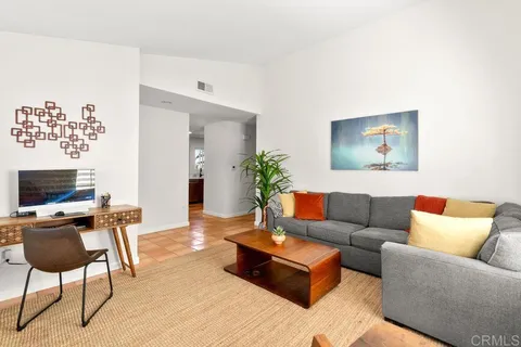 a living room with furniture a couch and a flat screen tv