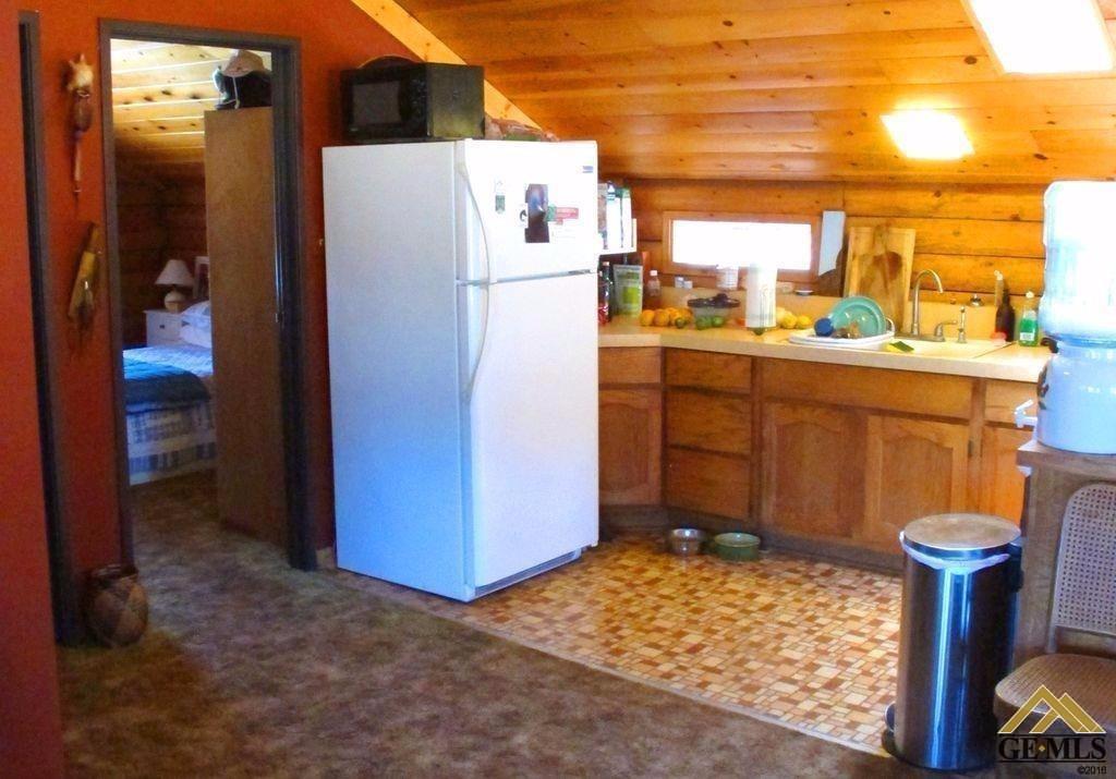 Undisclosed Address Caliente, CA 93518 - Photo 13 of 14 a kitchen with a refrigerator and a stove