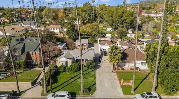 an aerial view of a residential houses with outdoor space