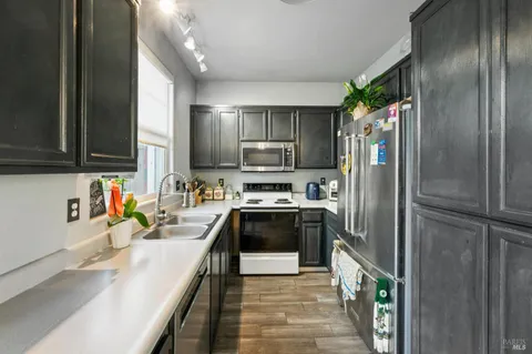 a kitchen with stainless steel appliances granite countertop a refrigerator and a sink