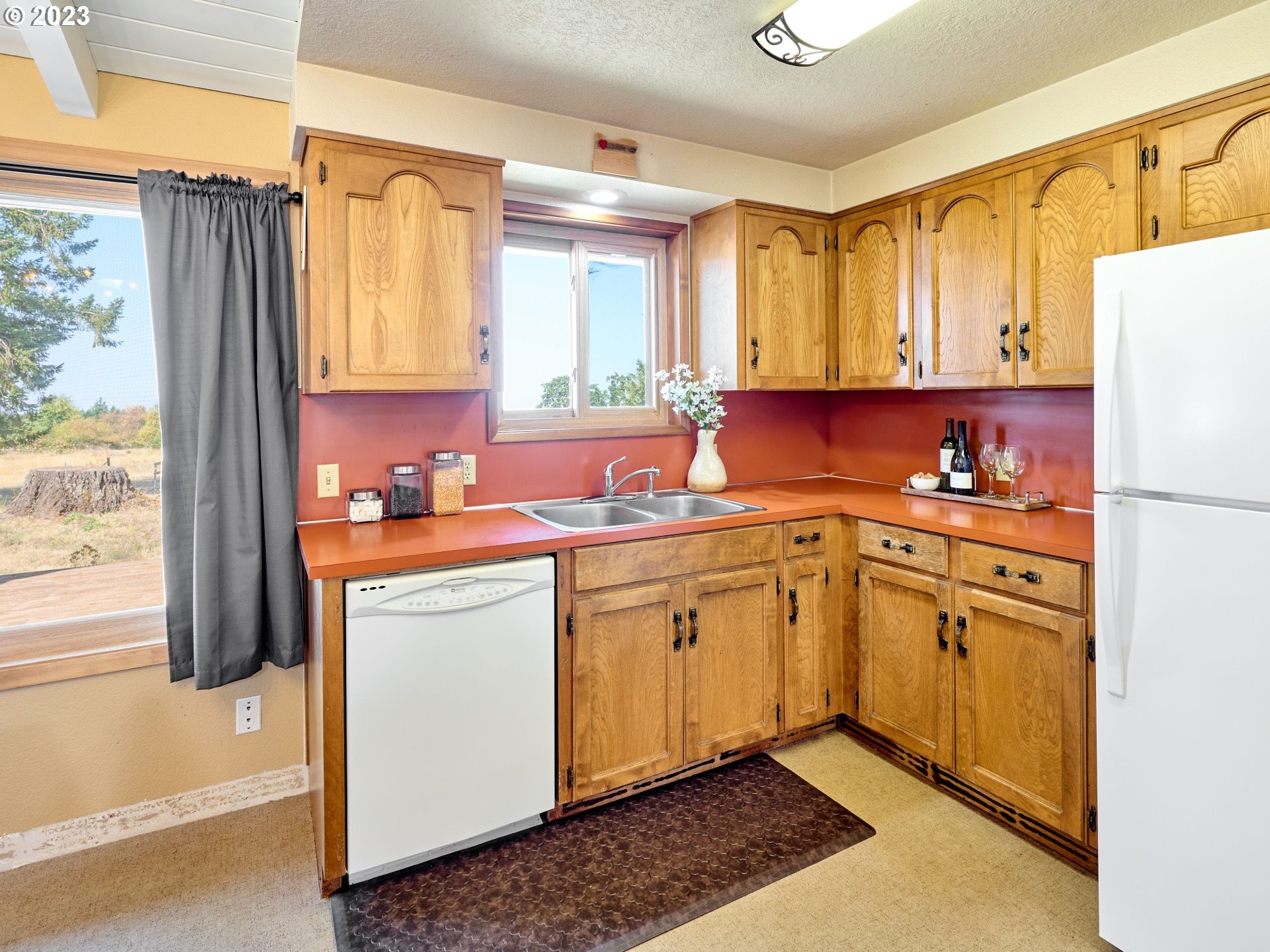 3661 Seminole Road Northeast Silverton, OR 97381 - Photo 12 of 48 a kitchen with a refrigerator a sink dishwasher and cabinets with wooden floor