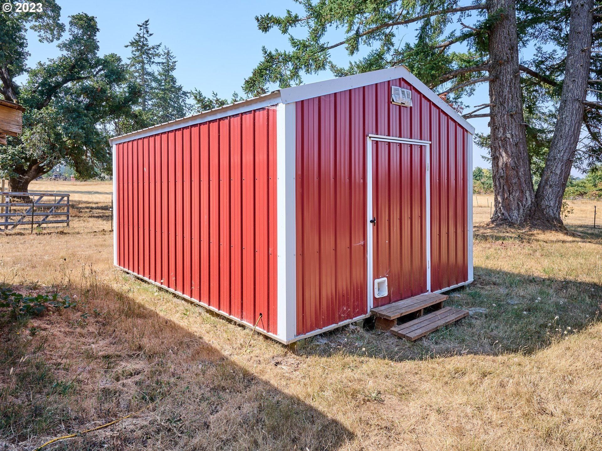 3661 Seminole Road Northeast Silverton, OR 97381 - Photo 39 of 48 a view of a backyard with a barbeque and wooden fence