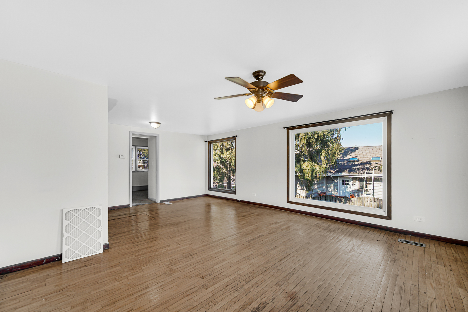 716 Chestnut Street Lemont, IL 60439 - Photo 5 of 20 an empty room with window and ceiling fan