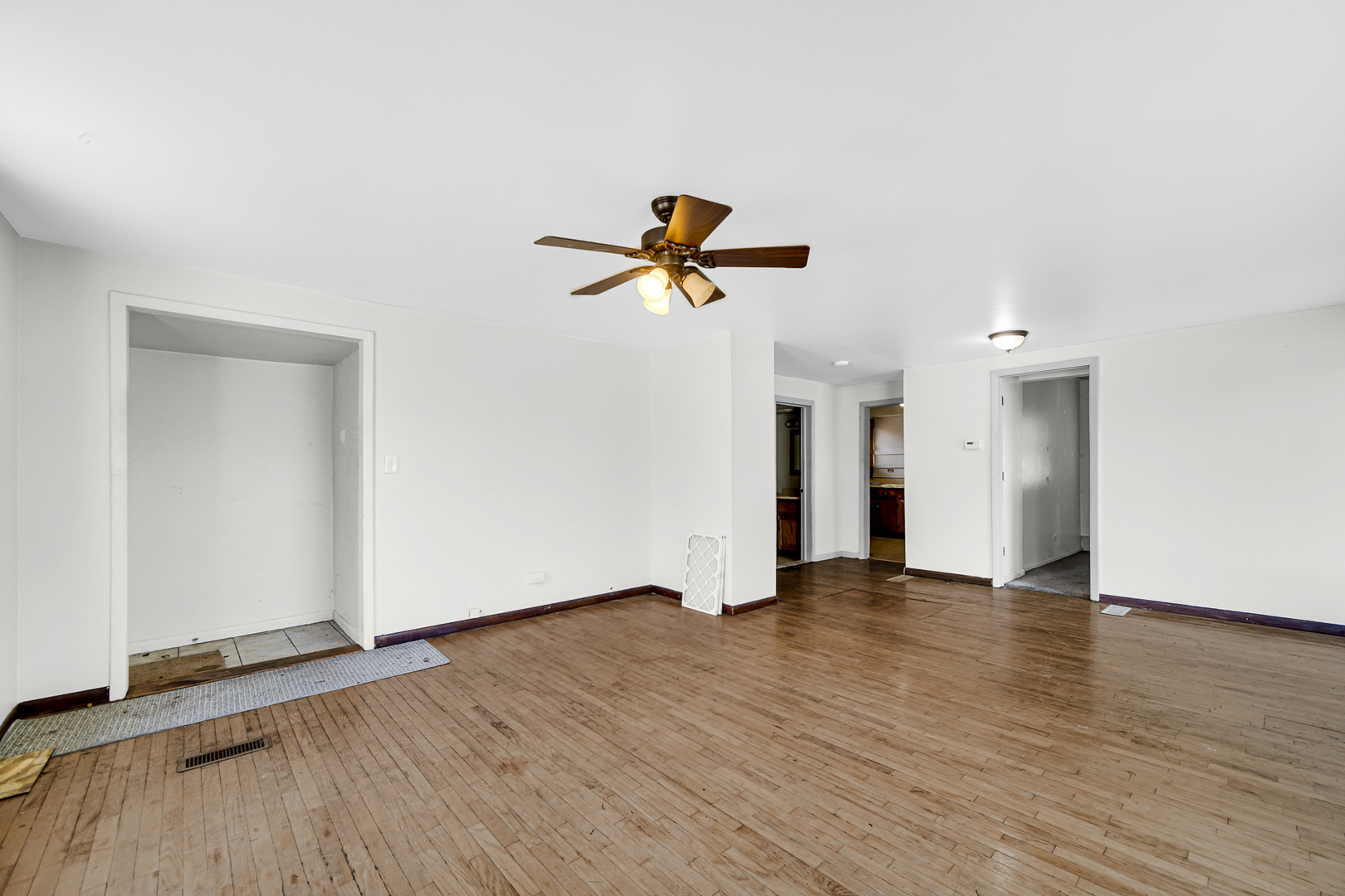 716 Chestnut Street Lemont, IL 60439 - Photo 7 of 20 an empty room with wooden floor and ceiling fan