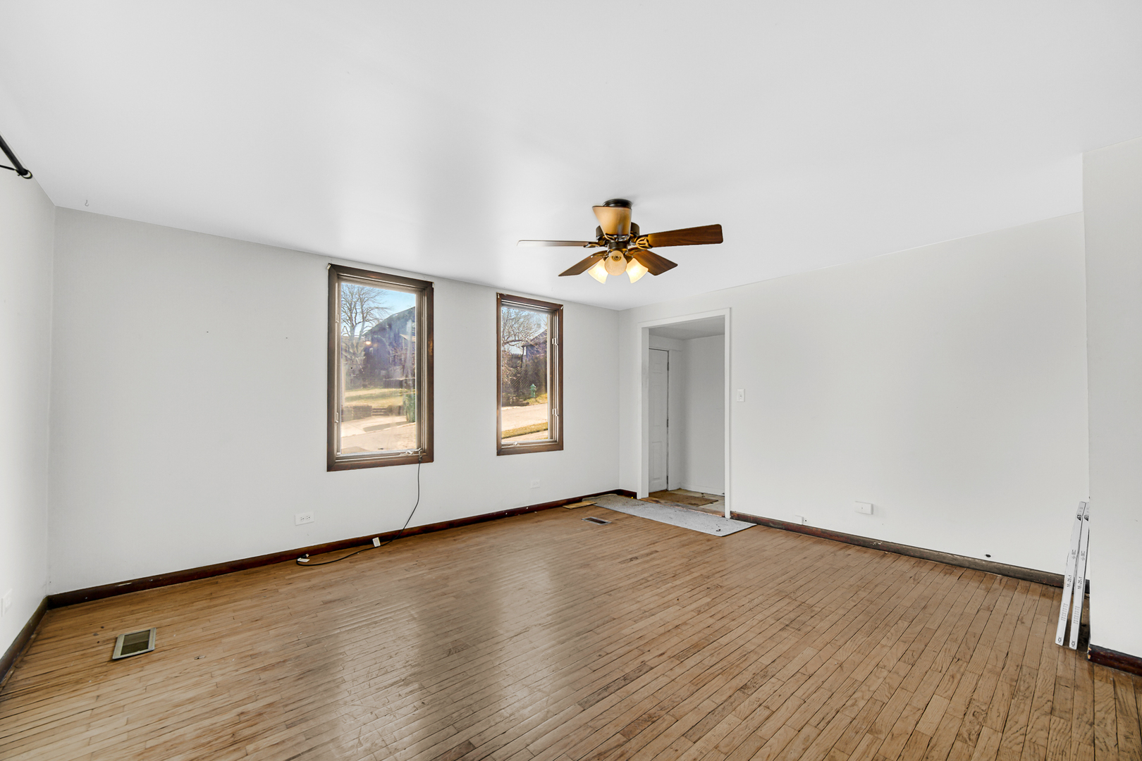 716 Chestnut Street Lemont, IL 60439 - Photo 8 of 20 an empty room with wooden floor and windows