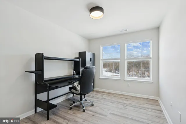 a view of workspace with wooden floor windows