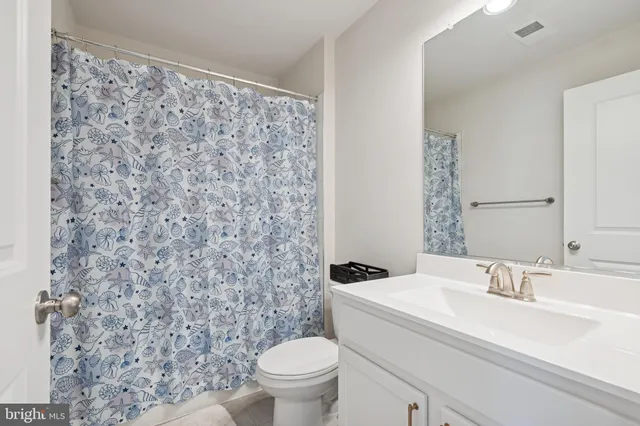 a bathroom with a sink toilet and a mirror