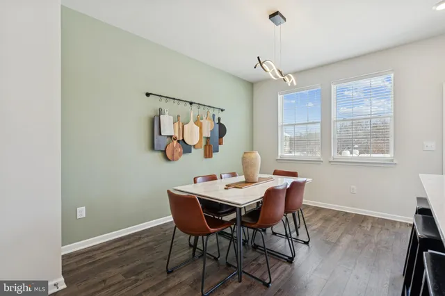 a view of a dining room with furniture a chandelier and wooden floor