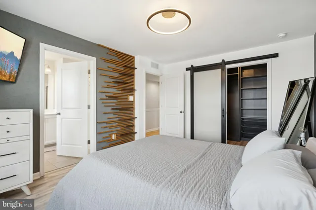 a bedroom with a bed and a television