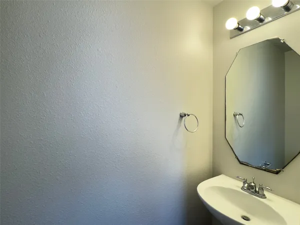 a bathroom with a sink and mirror