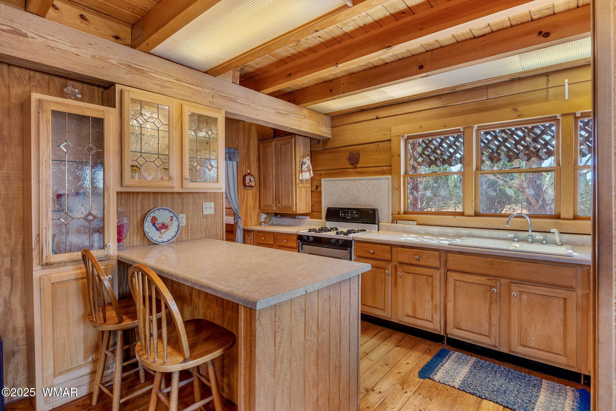 4 County Road Concho, AZ 85924 - Photo 5 of 25 a kitchen with a sink and wooden cabinets