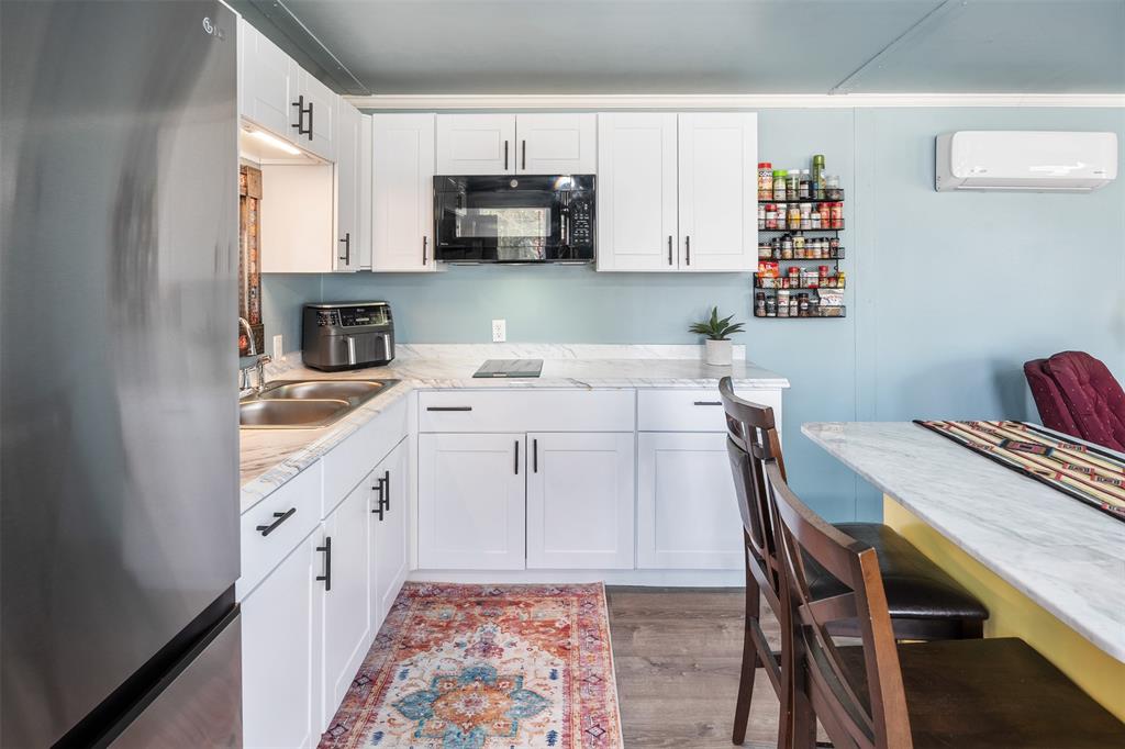 205 Scott Lane Mabank, TX 75156 - Photo 19 of 21 a view of kitchen with sink microwave and cabinets