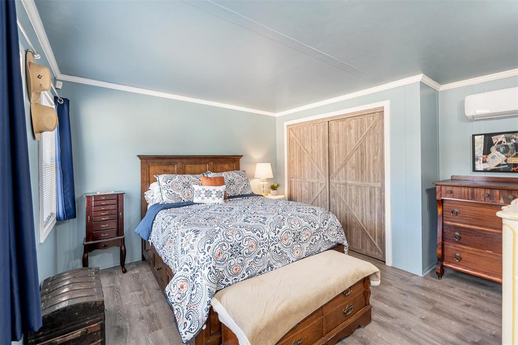 205 Scott Lane Mabank, TX 75156 - Photo 6 of 21 a bedroom with a bed and wooden floor