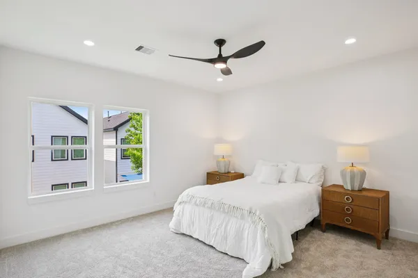 a bedroom with a bed and a window