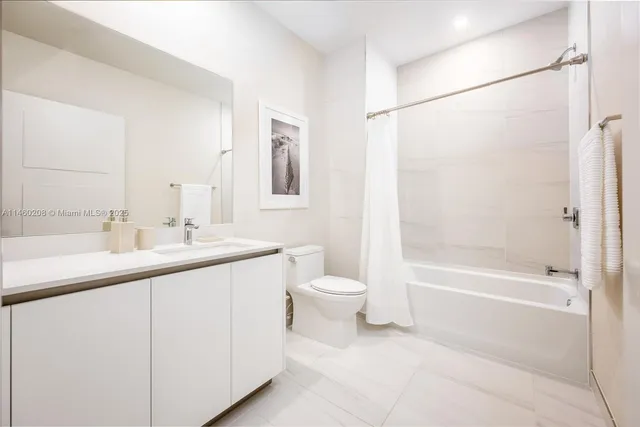 a bedroom with a large bed and a large window