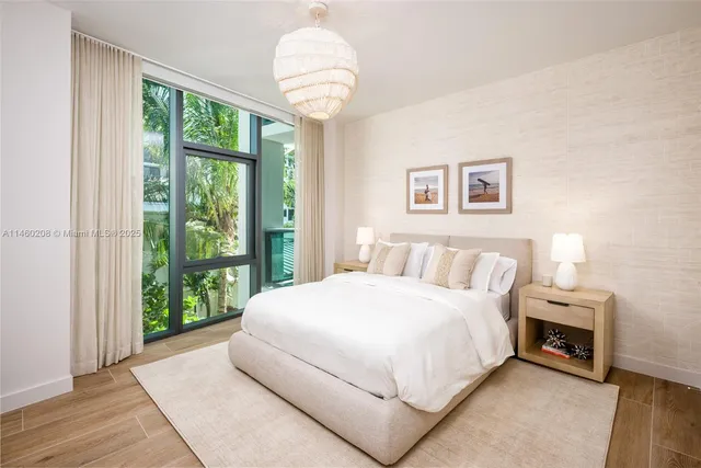 a bedroom with two beds and a large window