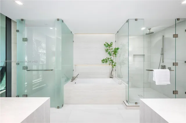 a bathroom with a tub shower and a sink