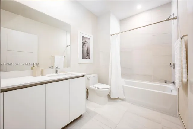 a bathroom with a double vanity sink toilet and shower