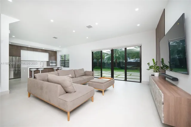 a living room with furniture and a large window with outer view