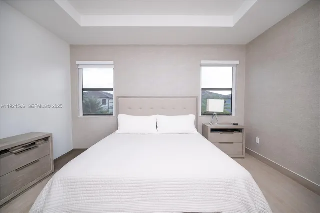 a large white bed in a white room