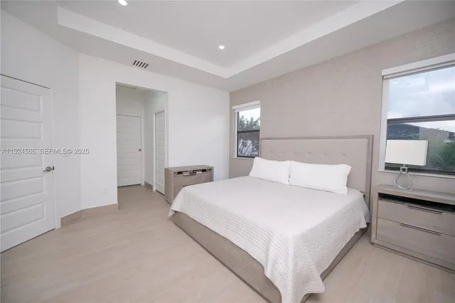 a large white bed in a white room