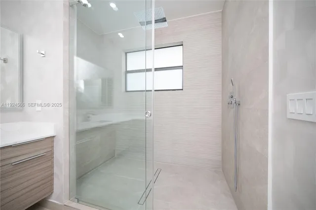 a bathroom with a bathtub and shower