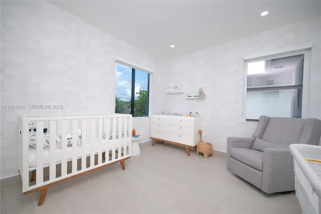 a spacious bedroom with a bed and a window