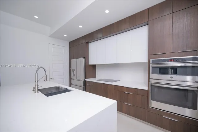 a kitchen with a sink and a stove top oven