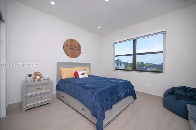 a bed room with a bed and a painting on the wall