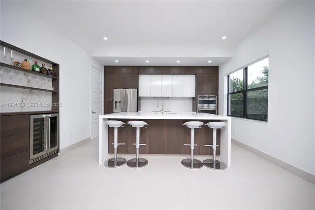 a kitchen with a sink a counter top space and appliances