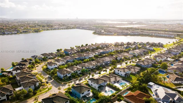 an aerial view of a house with a garden and lake view