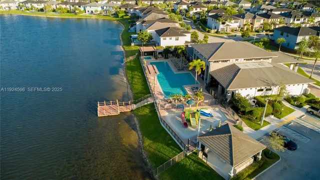 an aerial view of residential houses with yard
