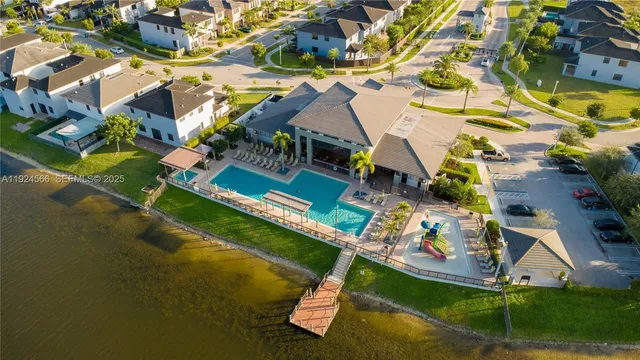 an aerial view of a house with a garden and outdoor seating