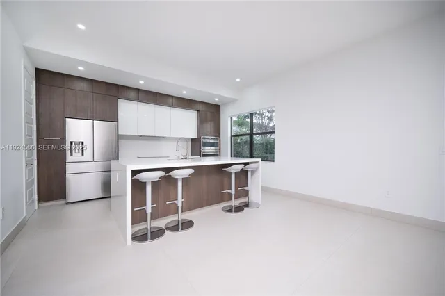 a room with a window and chairs