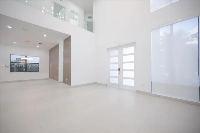 an empty room with windows and closet