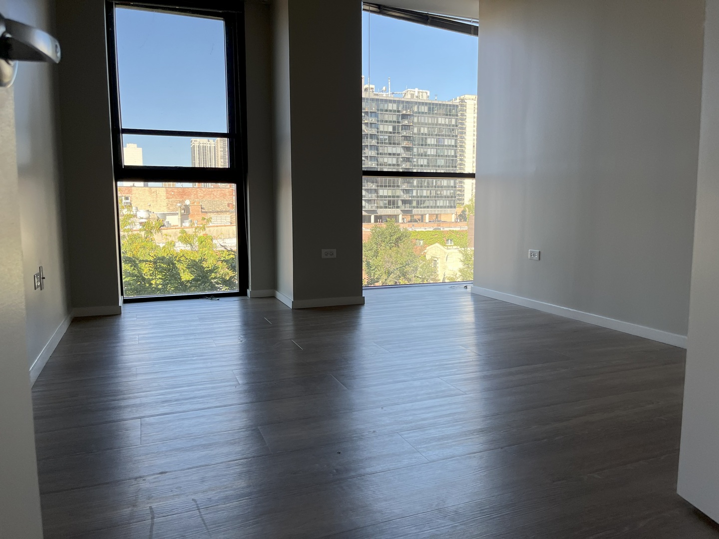 211 West Scott Street, Unit 508 Chicago, IL 60610 - Photo 11 of 22 a view of an empty room with wooden floor and a window