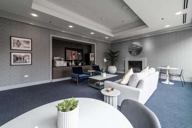 a living room with furniture kitchen view and a fireplace