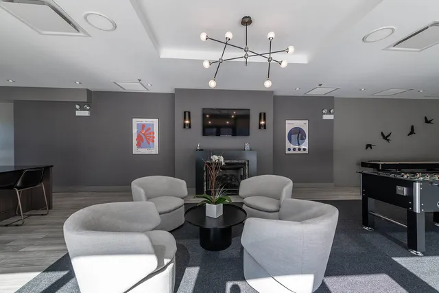 a living room with fireplace furniture and a flat screen tv