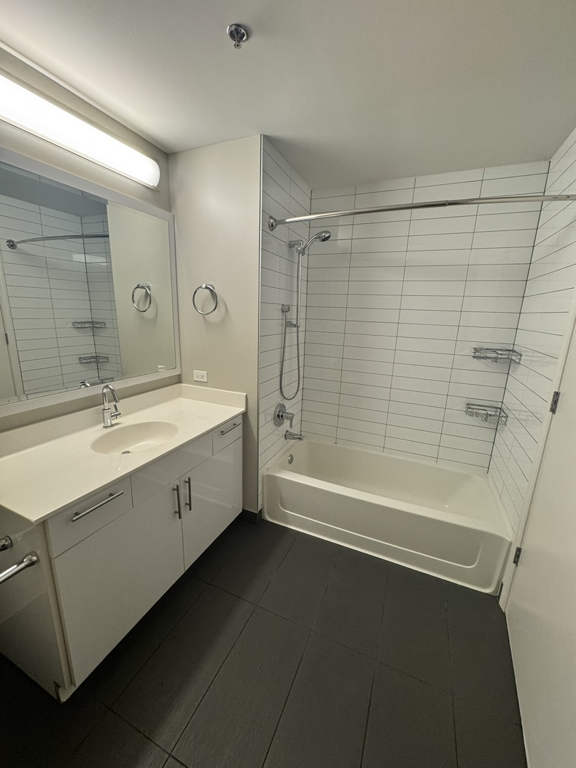 211 West Scott Street, Unit 508 Chicago, IL 60610 - Photo 6 of 22 a spacious bathroom with a bathtub a sink a mirror and a shower