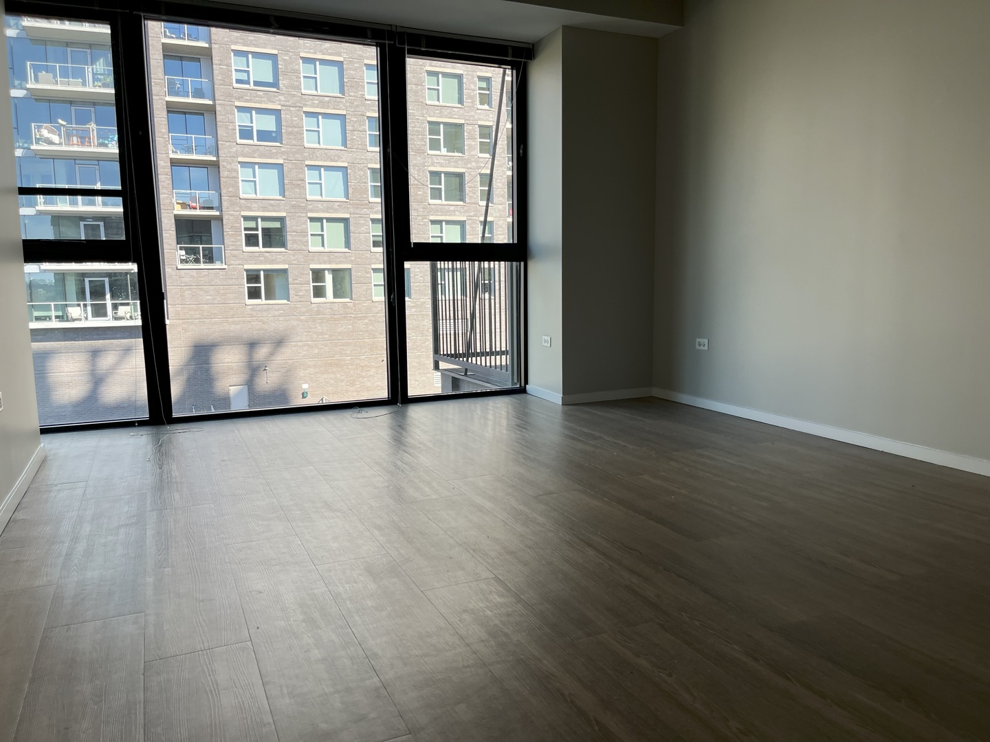 211 West Scott Street, Unit 508 Chicago, IL 60610 - Photo 8 of 22 a view of an empty room with wooden floor and a window