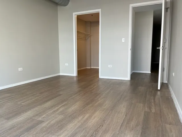 a view of a room with wooden floor and floor to ceiling window