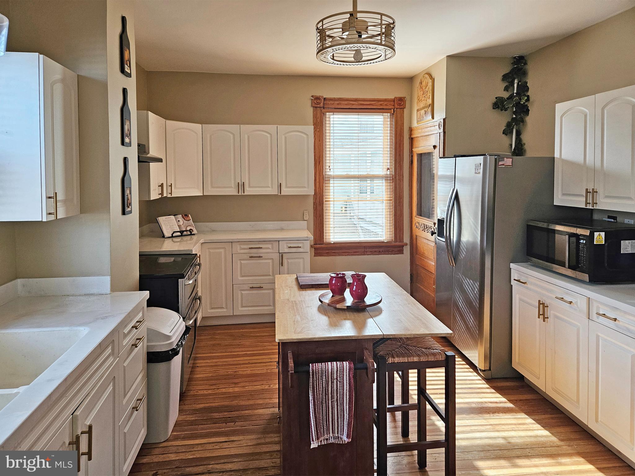 20 Blue Ridge Avenue Front Royal, VA 22630 - Photo 20 of 51 a kitchen with a refrigerator a stove a sink dishwasher and wooden cabinets with wooden floor