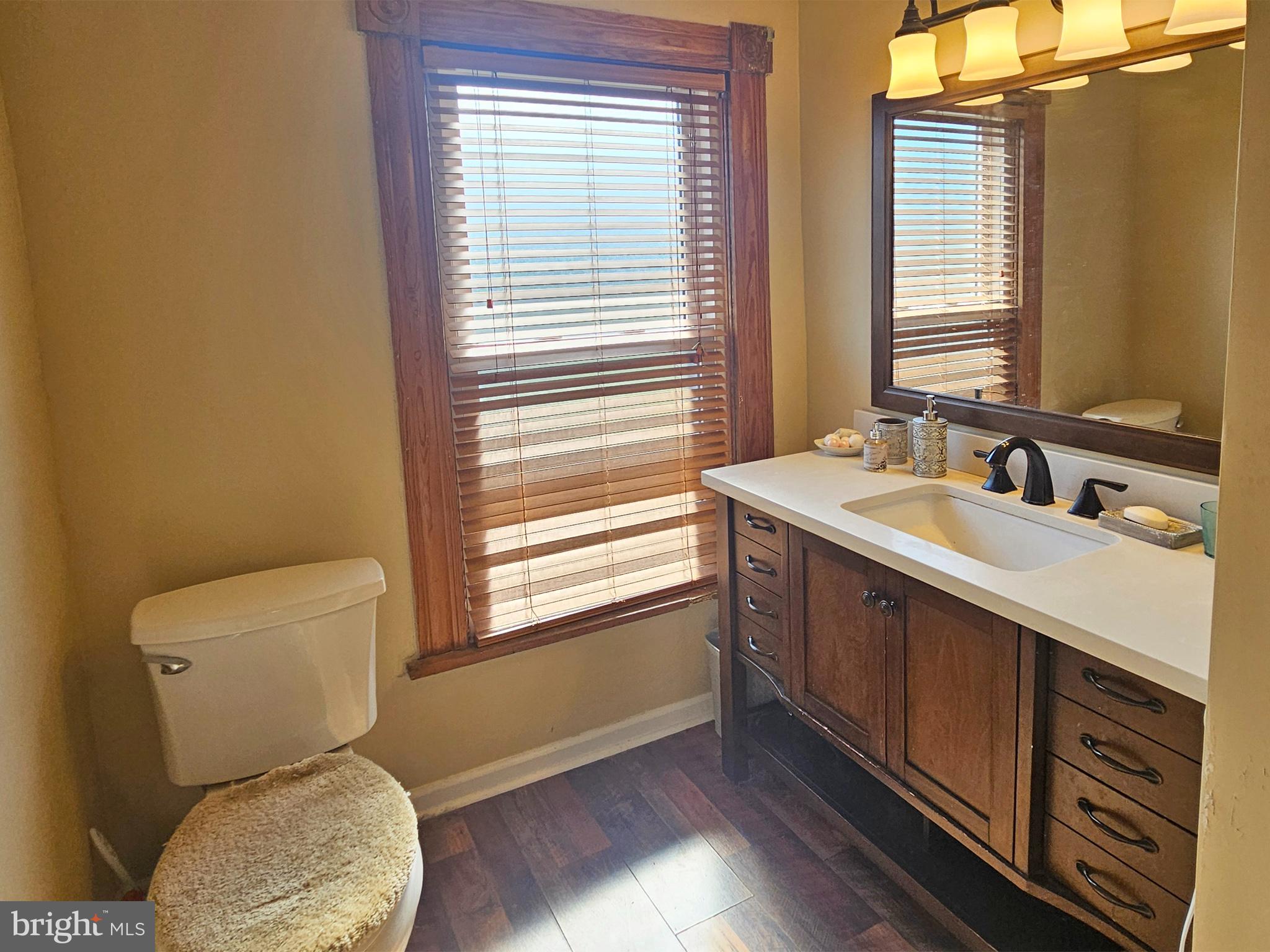 20 Blue Ridge Avenue Front Royal, VA 22630 - Photo 31 of 51 a bathroom with a toilet sink and mirror