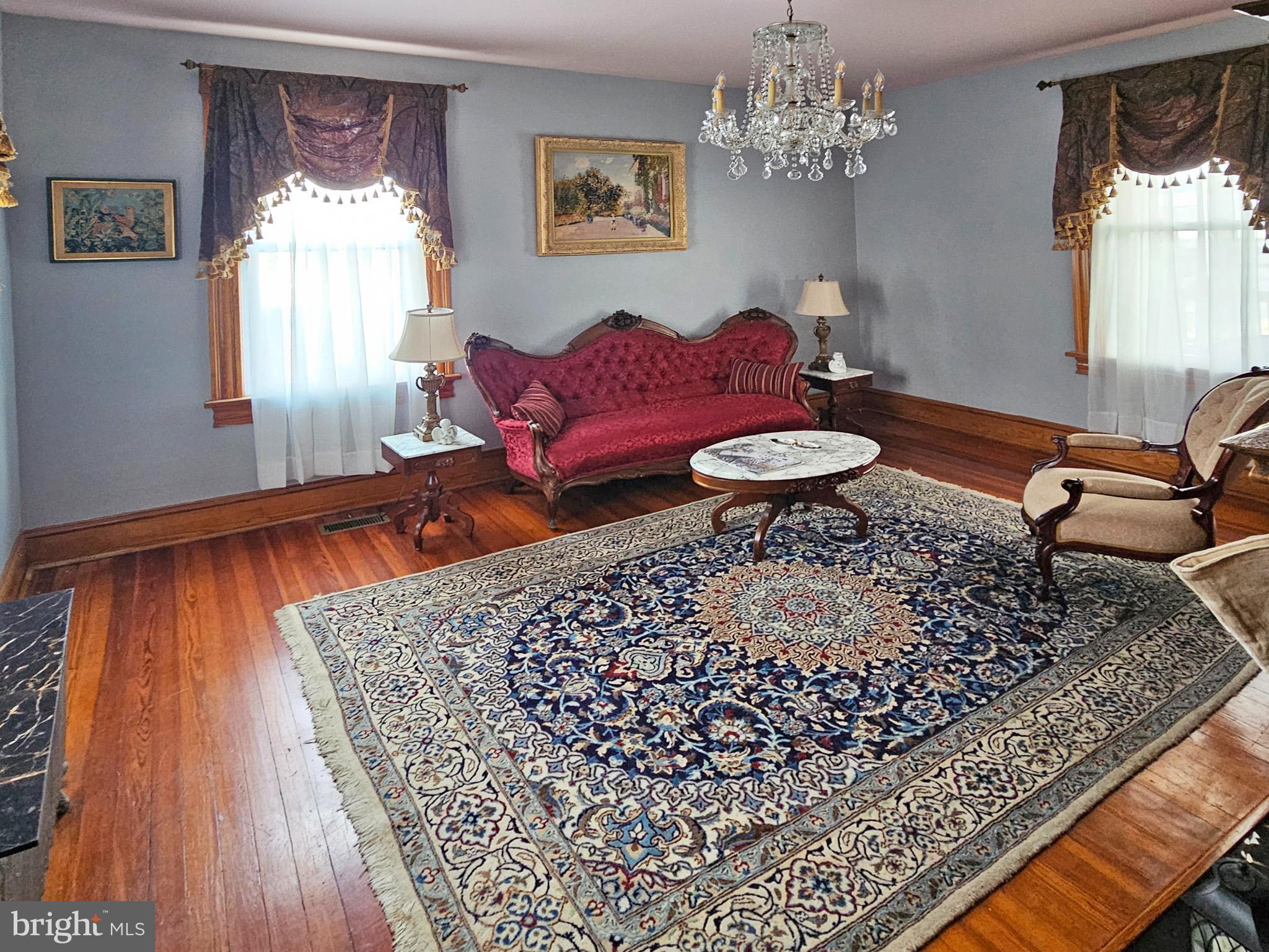 20 Blue Ridge Avenue Front Royal, VA 22630 - Photo 8 of 51 a living room with furniture and a chandelier