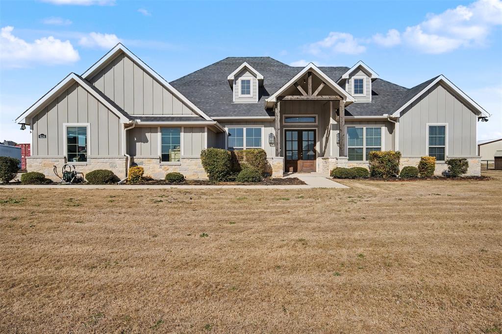 6334 Rustic Edge Street Godley, TX 76044 - Photo 1 of 1 Craftsman-style home featuring board and batten siding, french doors, stone, and a front yard