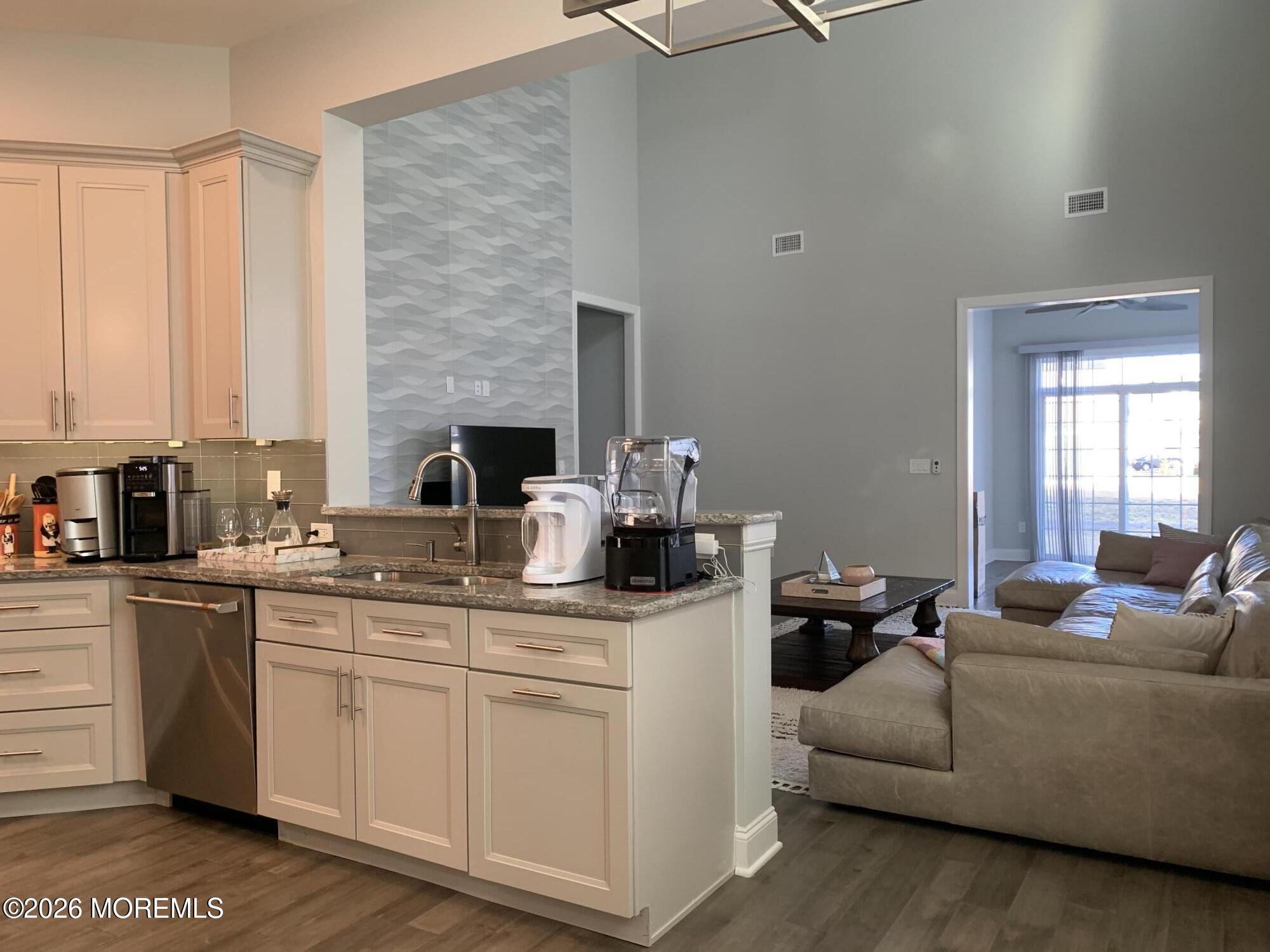 67 Samjan Circle Hightstown, NJ 08520 - Photo 6 of 22 a living room with stainless steel appliances kitchen island granite countertop a sink and cabinets
