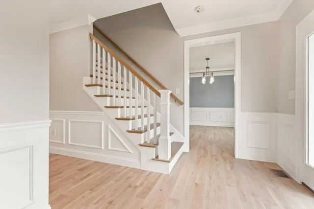 a view of entryway and hall with wooden floor