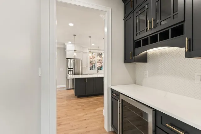 a view of kitchen with stainless steel appliances cabinets and wooden floor