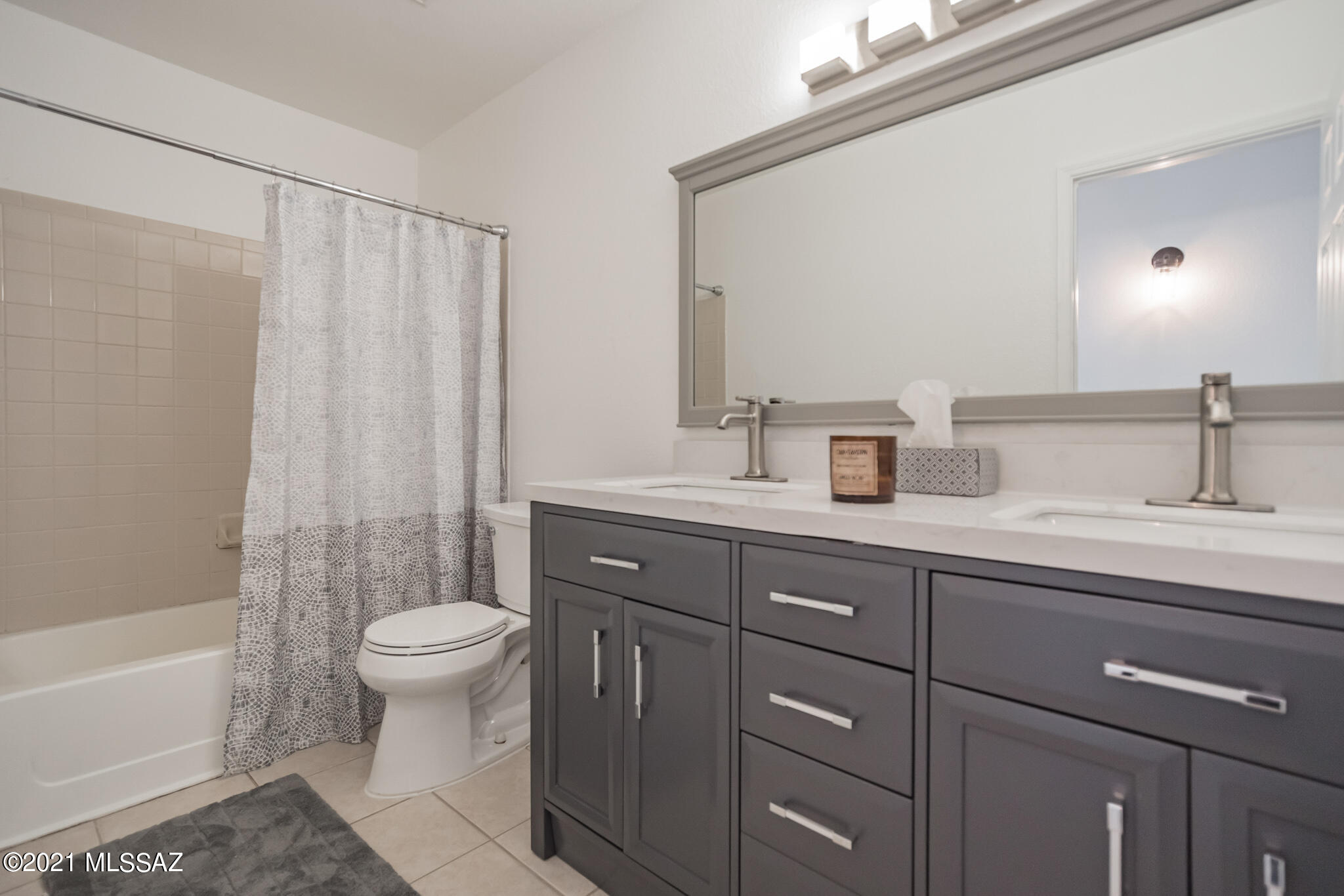 9671 East Azuma Way Tucson, AZ 85747 - Photo 23 of 31 a bathroom with a sink toilet a mirror and shower
