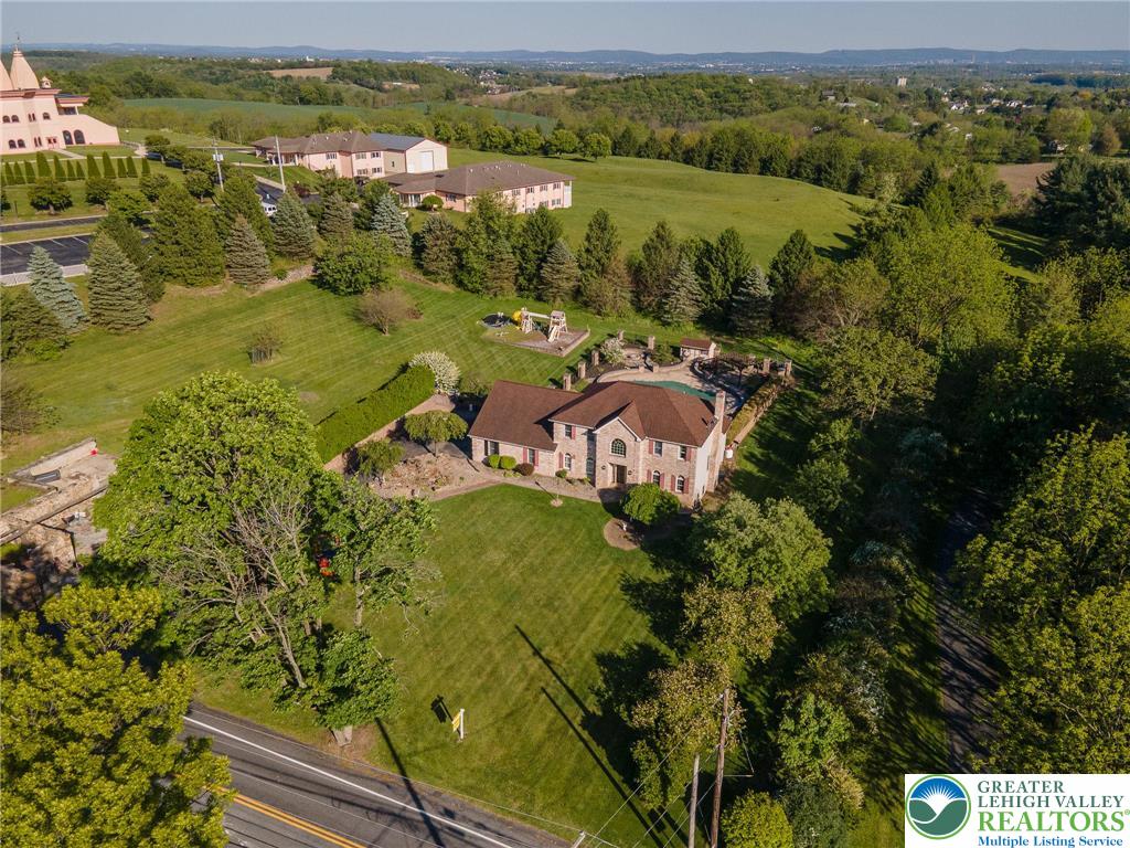 2170 Clearview Road Coplay, PA 18037 - Photo 71 of 75 Perched on a sprawling lot, this residence offers a refreshing pool amidst lush, verdant surroundings.